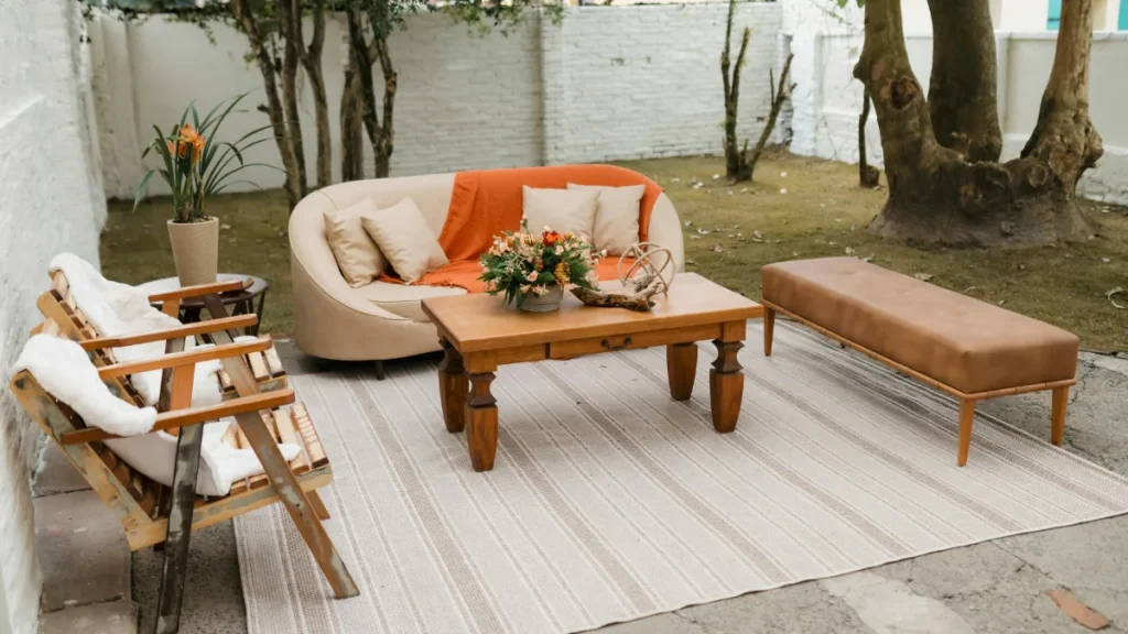Weatherproof Your Comfort With Cushions, Rugs, and Lighting