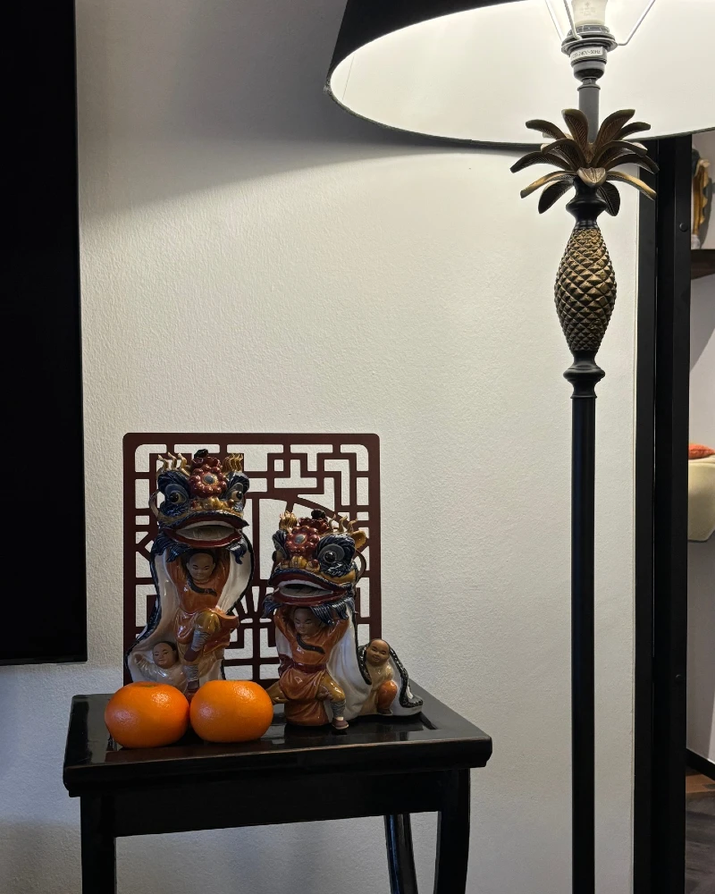 1. Black Pineapple Floor Lamp with Glossy Figurines and Bright Orange Accents