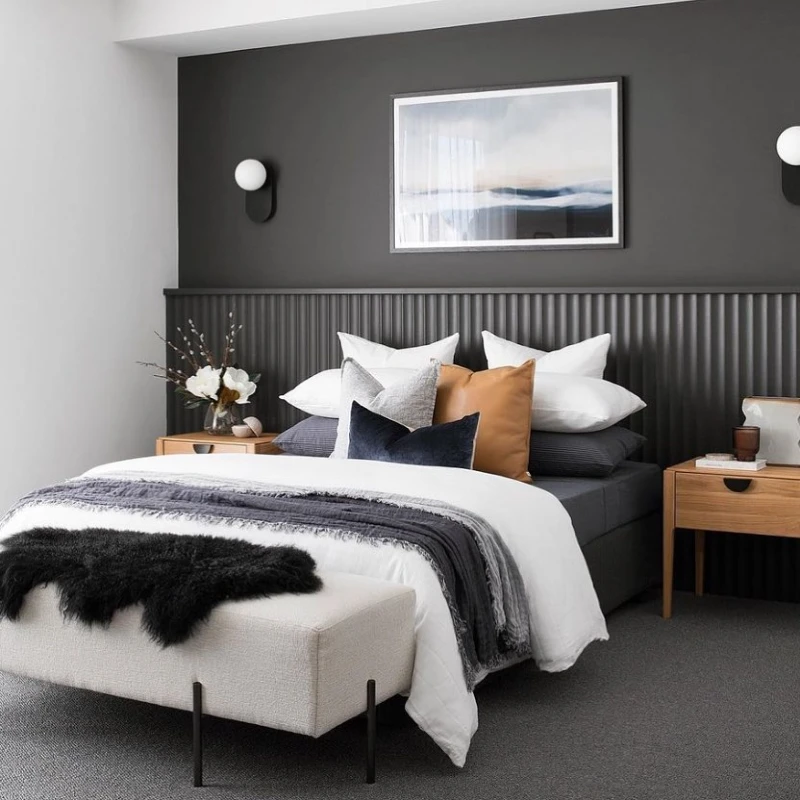 1. Charcoal Fluted Headboard with Crisp White Bedding and Caramel Accent Pillows