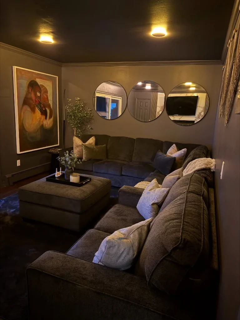 1. Charcoal Sectional with Round Mirrors and a Painted Black Ceiling