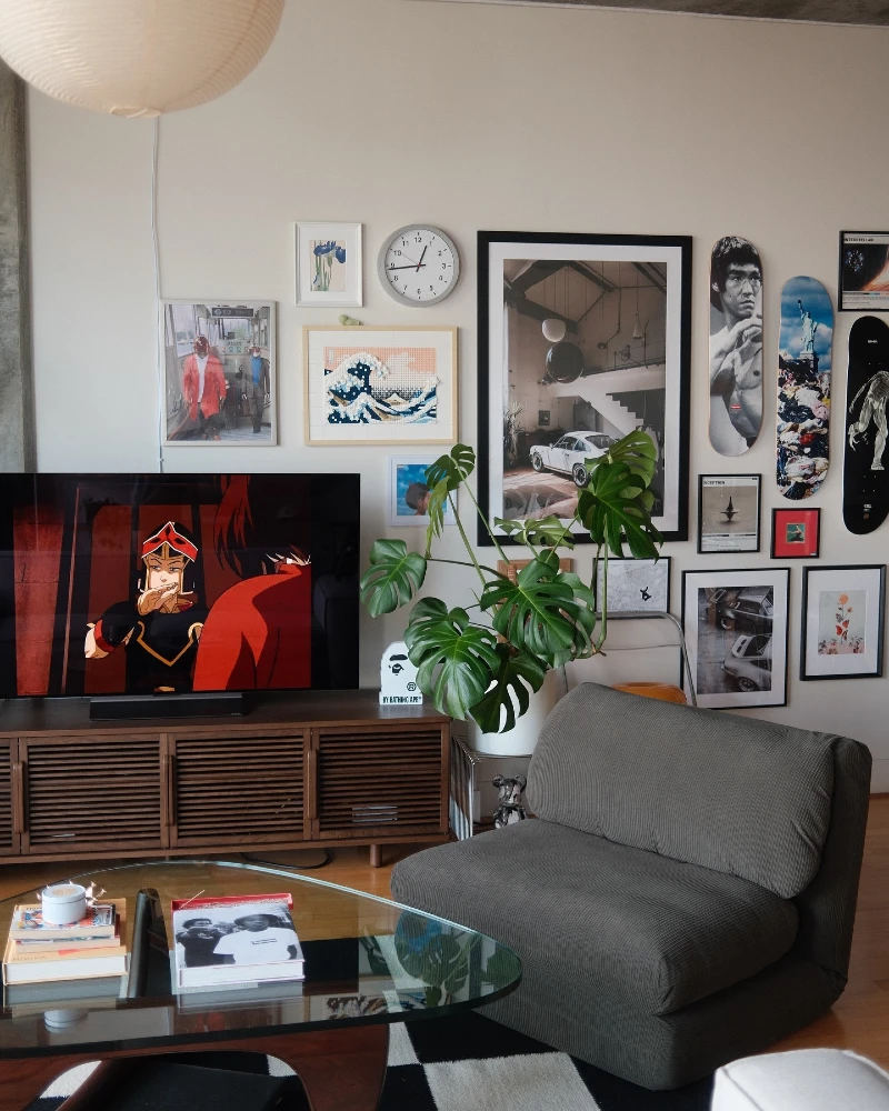 1. Gallery Wall with Skate Decks, Movie Prints, and a Low Wood Media Console