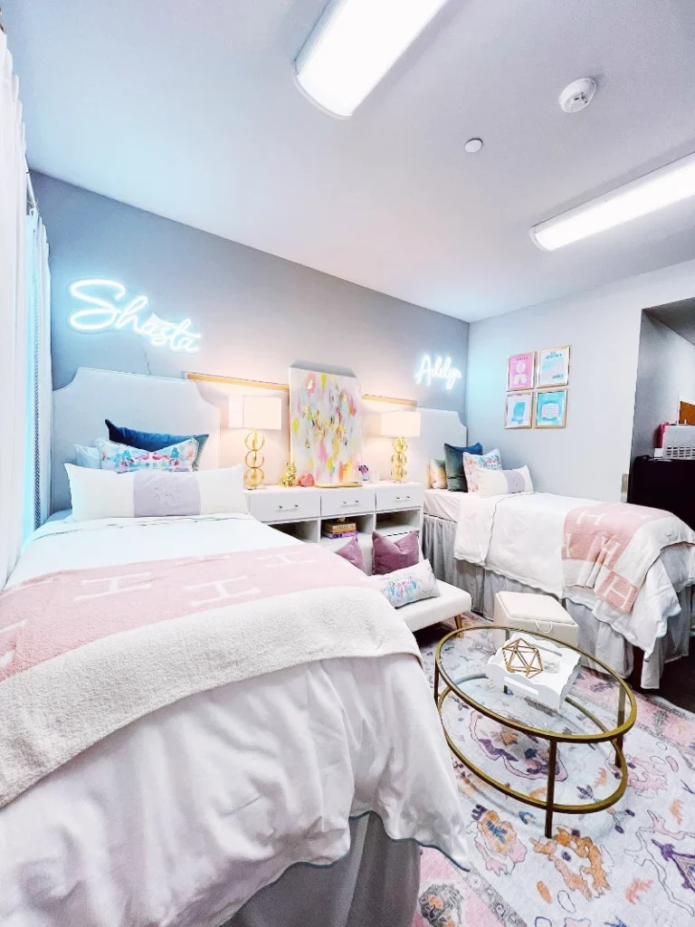 1. Pastel Twin Bed Suite with Neon Name Signs and Gold Lamps