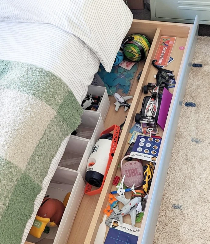 1. Pullout Toy Drawer with Pale Wood Compartments and Soft Striped Bedding