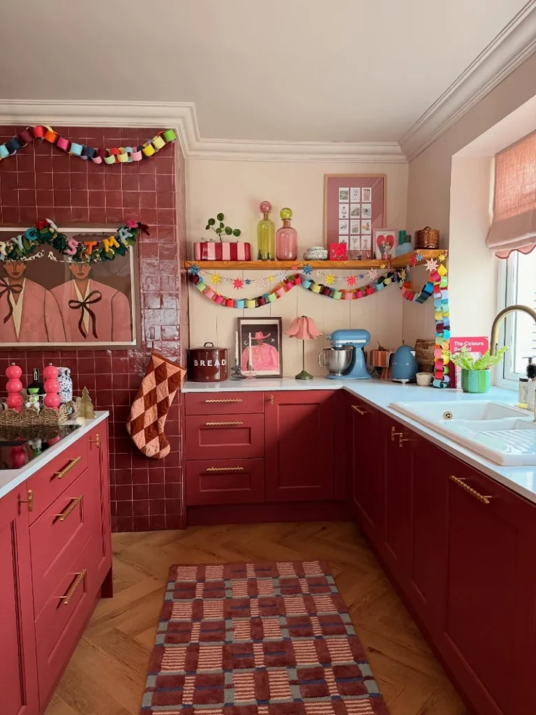 1. Red Tile Kitchen with Rainbow Paper Chains and Brass Pulls