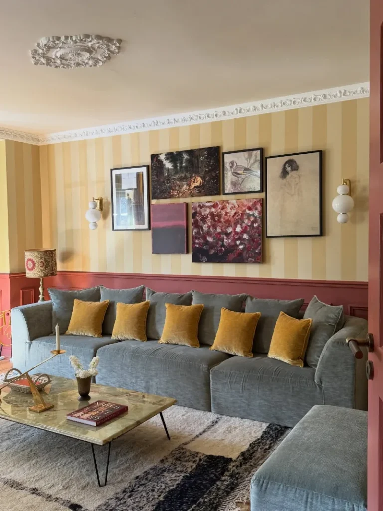1. Striped Accent Wall Gallery Above Velvet Sofa with Mustard Cushions