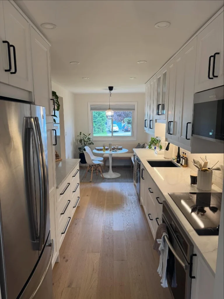 1. White Shaker Galley Kitchen with Black Pulls and a Window Breakfast Nook