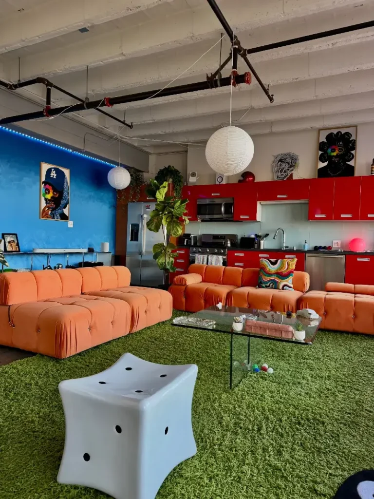 10. Blue Accent Wall with Orange Modular Sofas and Green Shag Rug