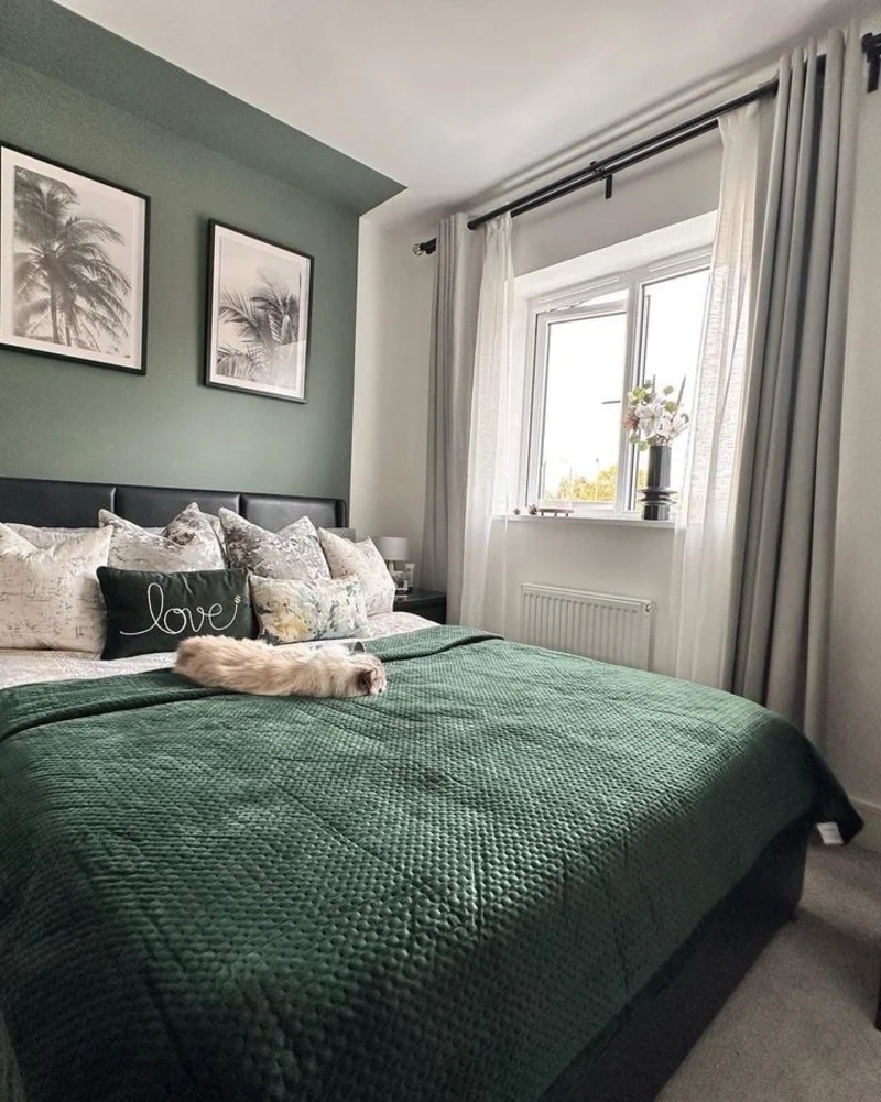 10. Green Accent Wall with Palm Prints, Gray Curtains, and a Textured Bedspread