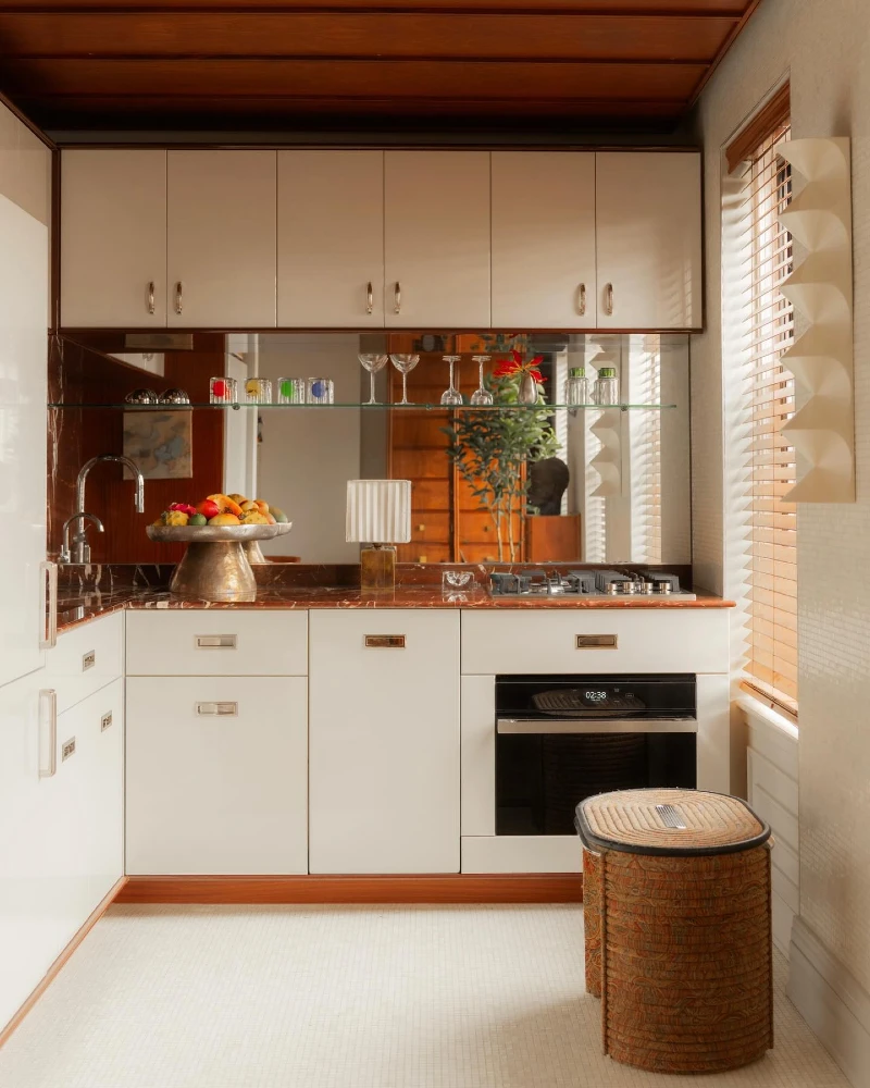 10. Mirror Shelf Kitchen with Copper Marble Counter and Warm Wood Ceiling Accents