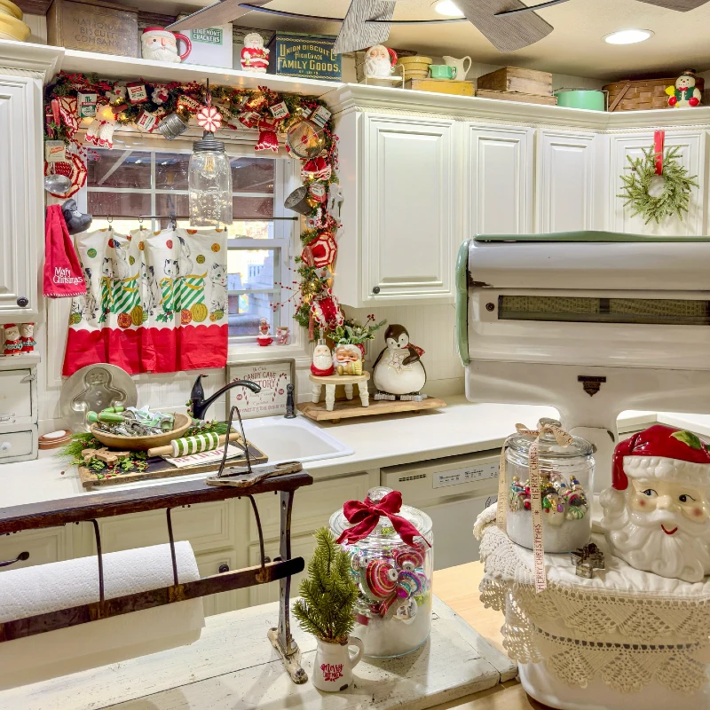 10. Vintage Christmas Kitchen with Santa Mugs, Garland, and Candy Jar Displays