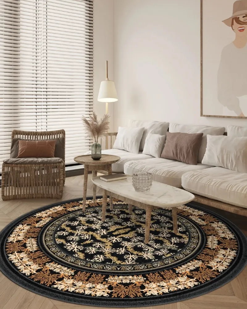 11. Black and Gold Circular Rug in Neutral Living Room with Woven Chair and Marble Coffee Table