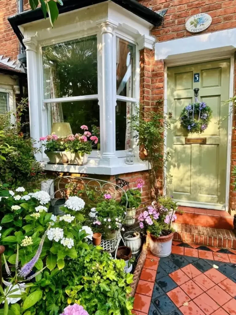 11. Cottage Entry Garden with Sage Green Door, Hydrangeas, and Layered Terracotta Pots
