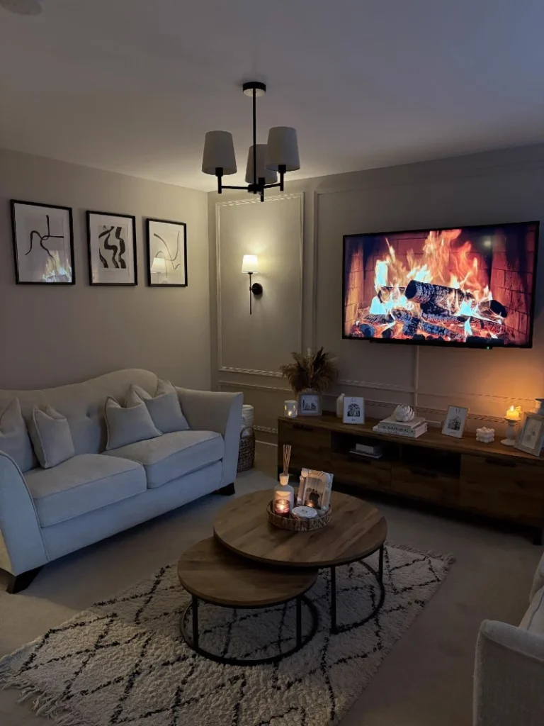 11. Fireplace TV Wall with Cream Sofa, Wood Console, and Round Nesting Tables