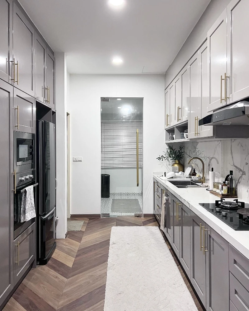 11. Glossy Grey Galley Kitchen with Brass Handles and Chevron Wood Floors