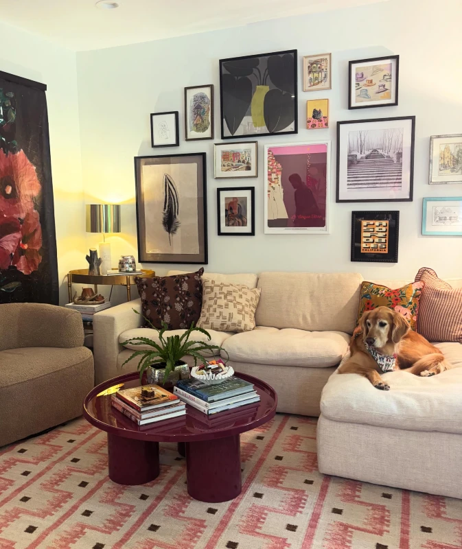 11. Warm Eclectic Living Room Gallery Wall with Mixed Frames Above Neutral Sofa and Burgundy Coffee Table