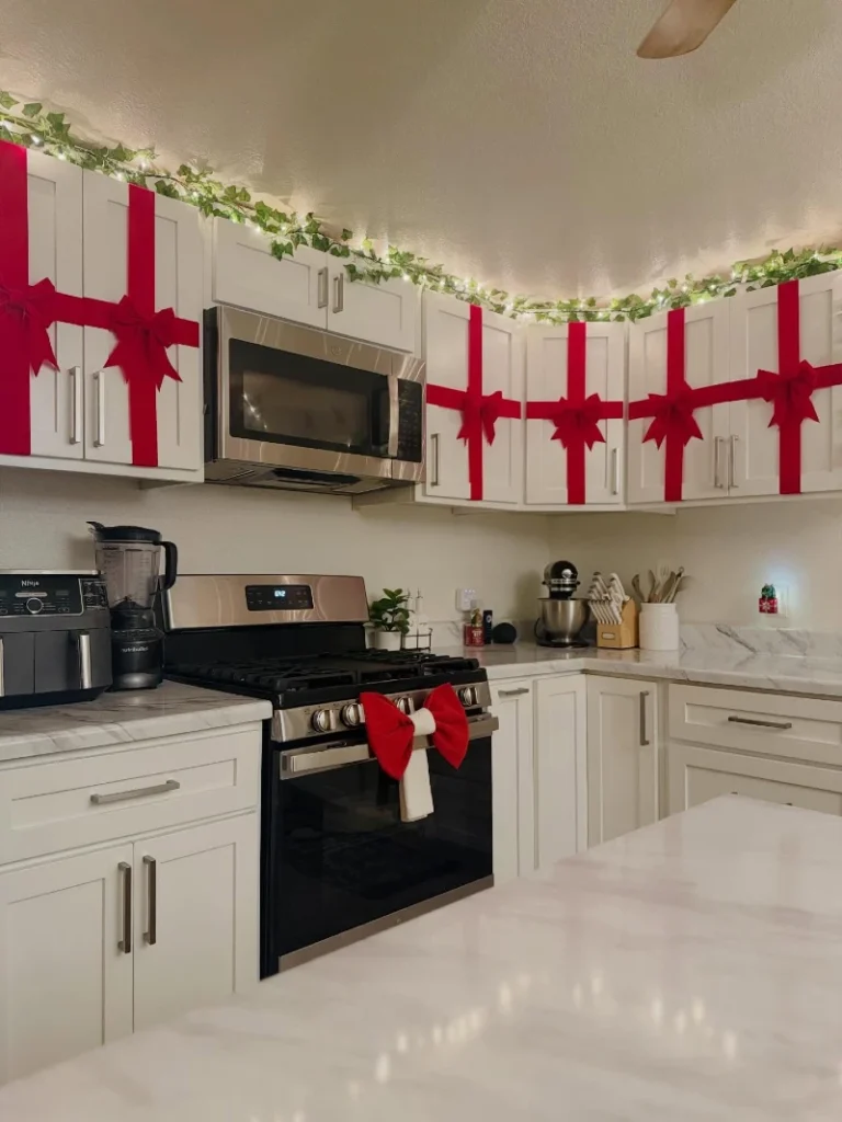 12. Gift-Wrapped White Cabinets with Red Ribbon Bows and Ivy Lights