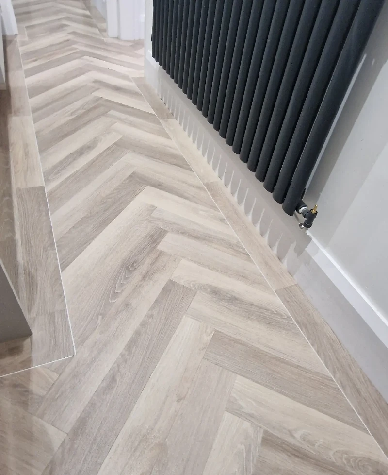 12. Pale Gray Herringbone Hallway Floor with Black Column Radiator