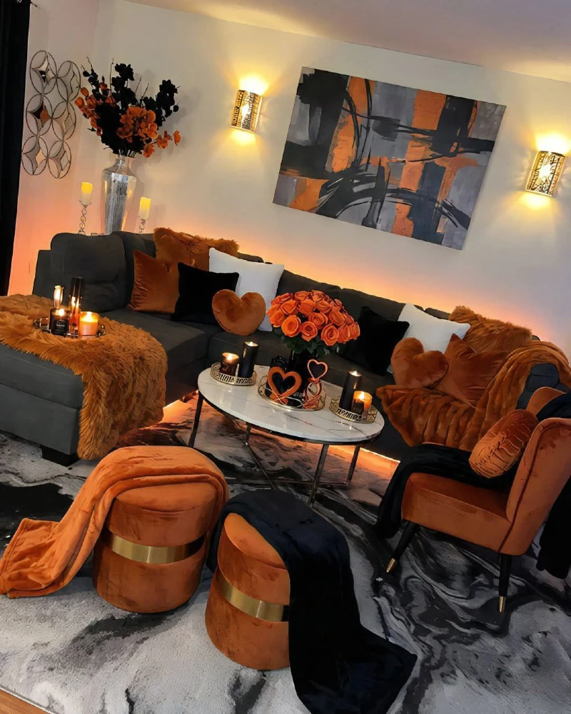 13. Burnt Orange Lounge with Black Sofa, Marble Coffee Table, and Candle Glow