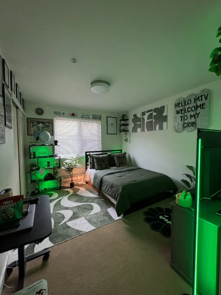 13. Gray Green Gamer Bedroom with LED Glow and Graphic Wall Art