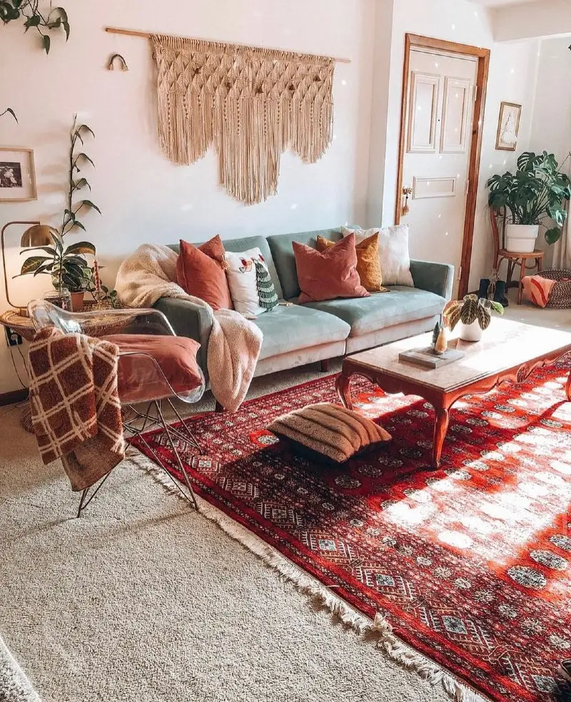 13. Layered Red Persian Rug Over Neutral Carpet in Eclectic Boho Living Room