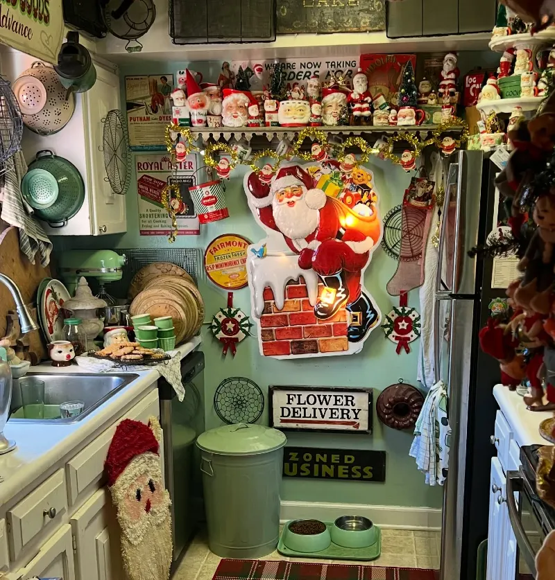 13. Maximalist Vintage Kitchen with Santa Shelf, Tin Signs, and Chimney Wall Art