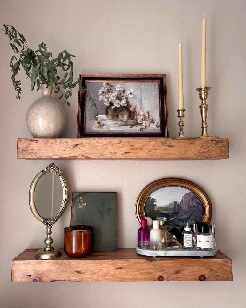 13. Vintage Vanity Shelves with Brass Candlesticks, Framed Florals, and Perfume Bottles