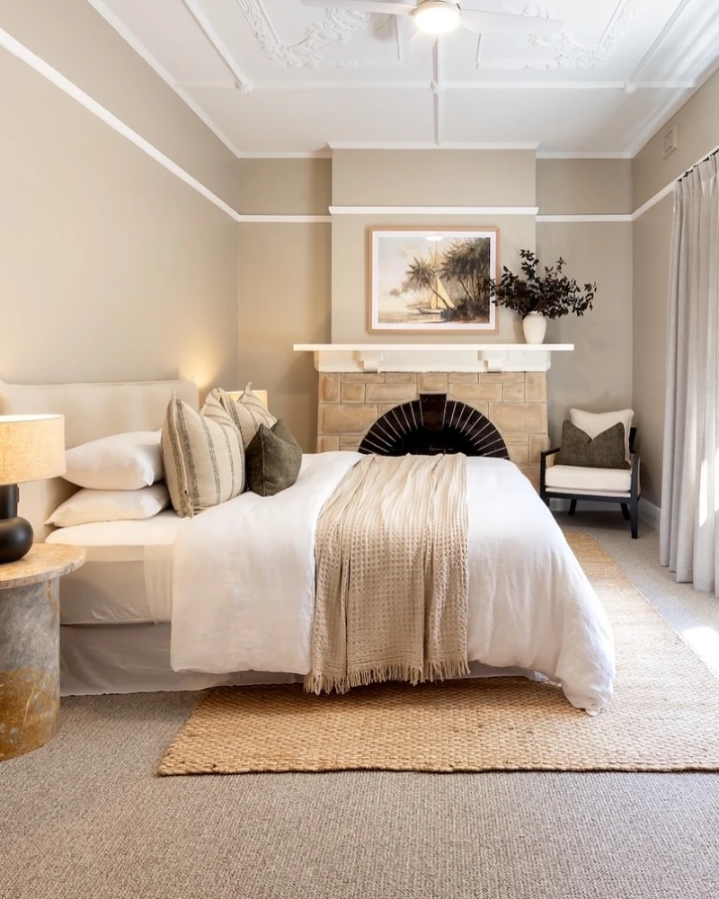 14. Beige Bedroom with Jute Layer Rug Over Full Grey Rental Carpet Base
