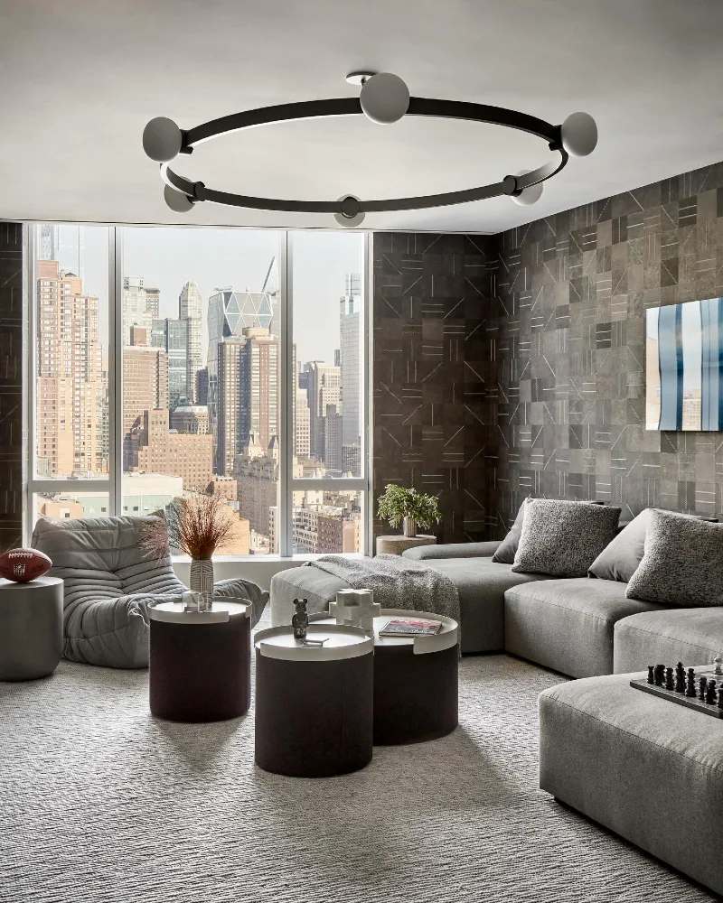 15. City View Lounge with Gray Modular Sofa, Patterned Wall Panels, and Ring Ceiling Light