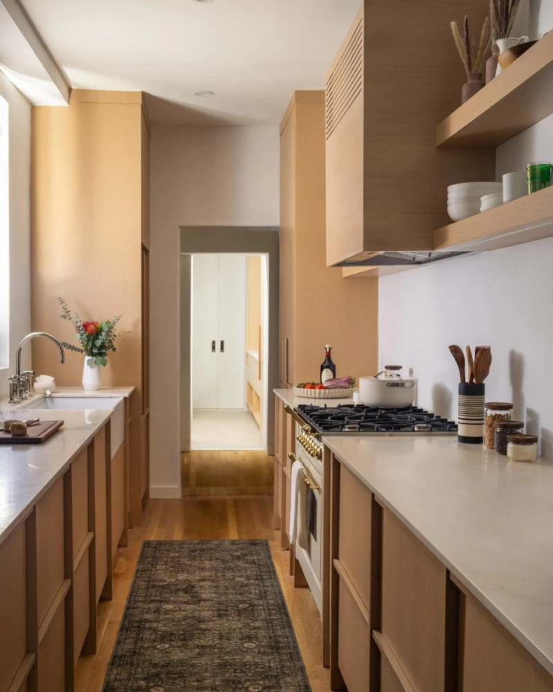 15. Honey Wood Galley Kitchen with White Counters, Open Shelves, and a Dark Vintage Runner