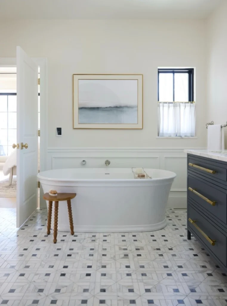 15. Marble Mosaic Bathroom Floor with Freestanding Tub and Navy Vanity