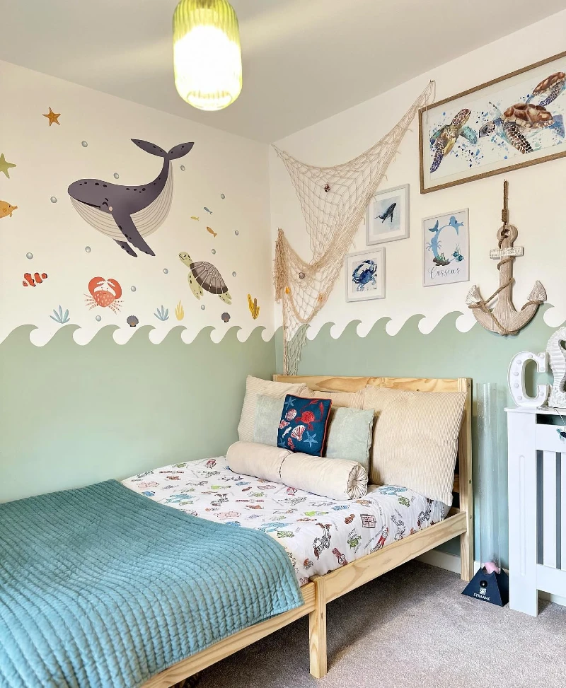 15. Ocean Wall Bedroom with Whale Decals, Netting, and Teal Quilted Bedding