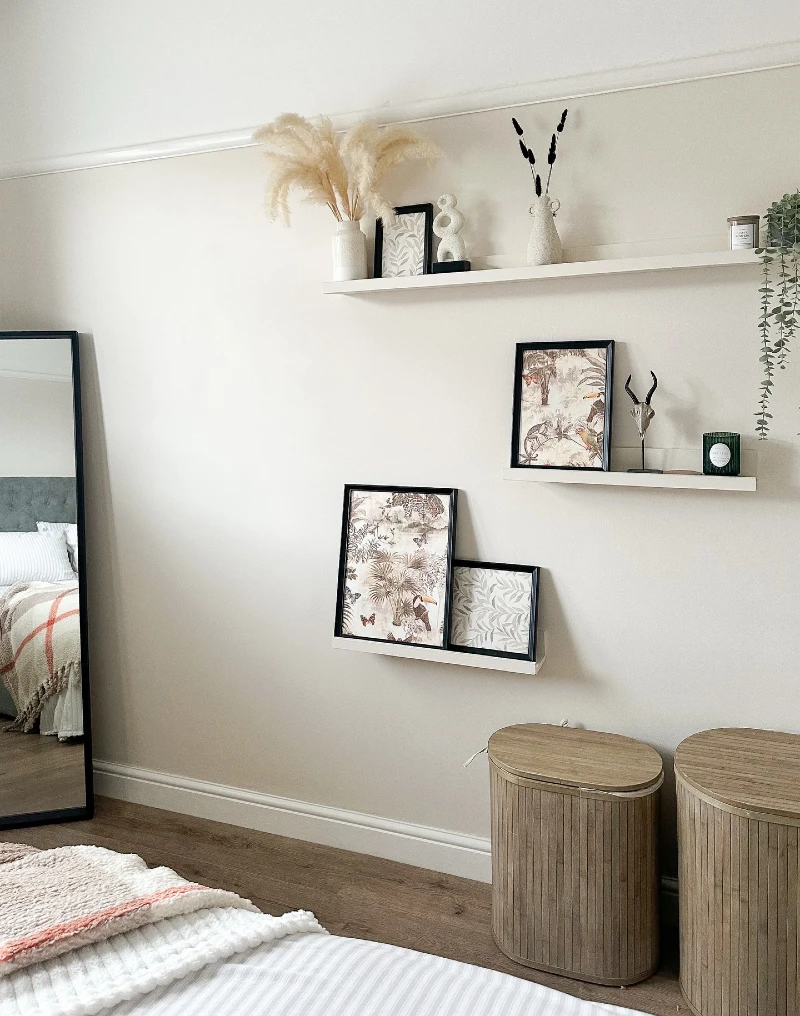 15. Staggered White Picture Ledges with Botanical Prints, Pampas, and Ribbed Wood Hampers