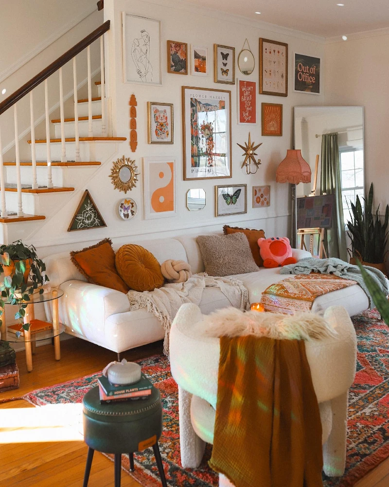15. Staircase Salon Gallery Wall with Layered Boho Frames and Warm Eclectic Living Room Corner