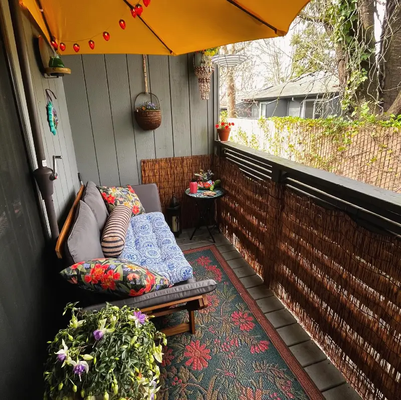 15. Yellow Umbrella Balcony Lounge with Bamboo Privacy Screen