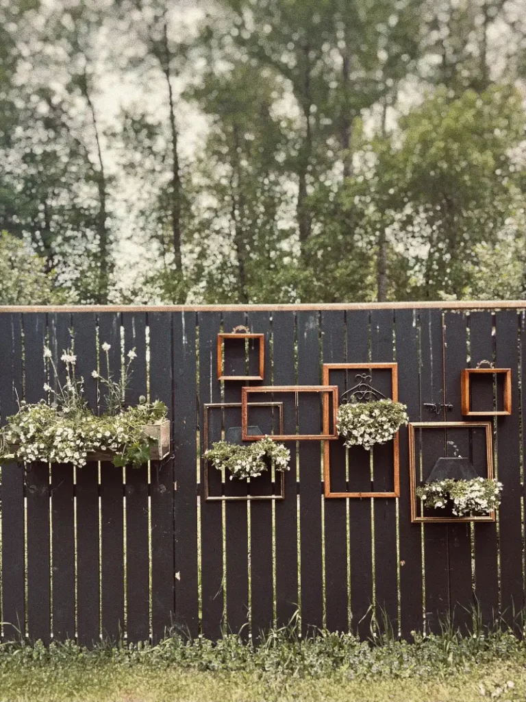 16. Black Slat Fence with Vintage Frames and White Flower Boxes