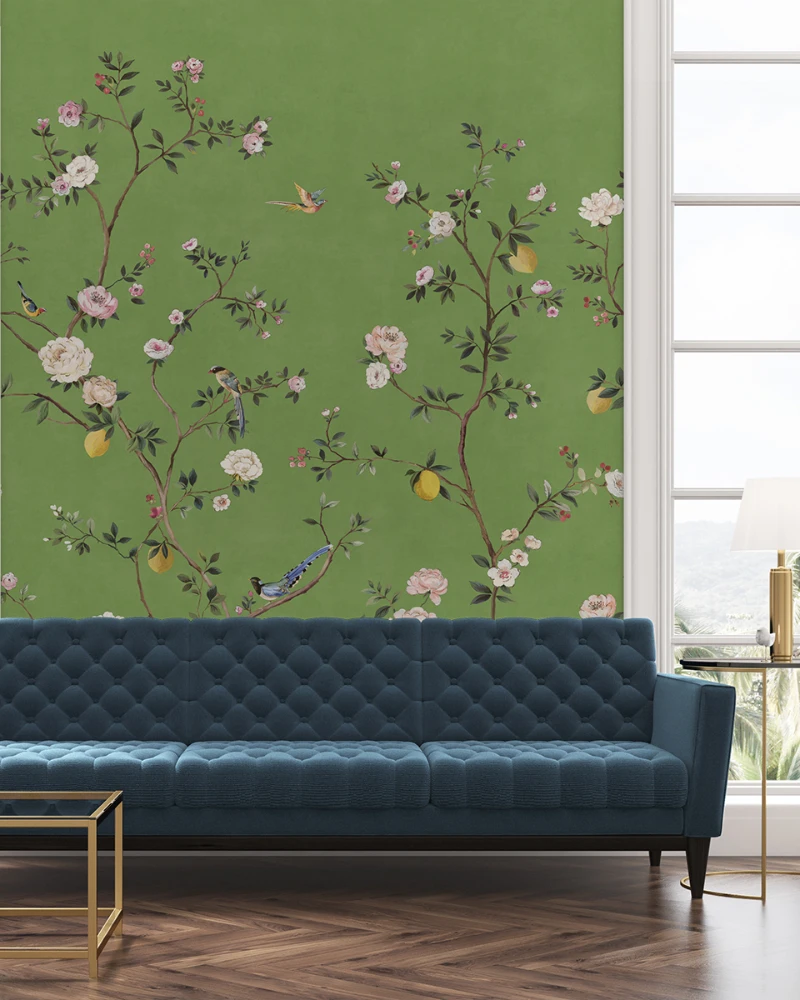 16. Emerald Bird Garden Wallpaper with Deep Blue Sofa and Gold Accent Table
