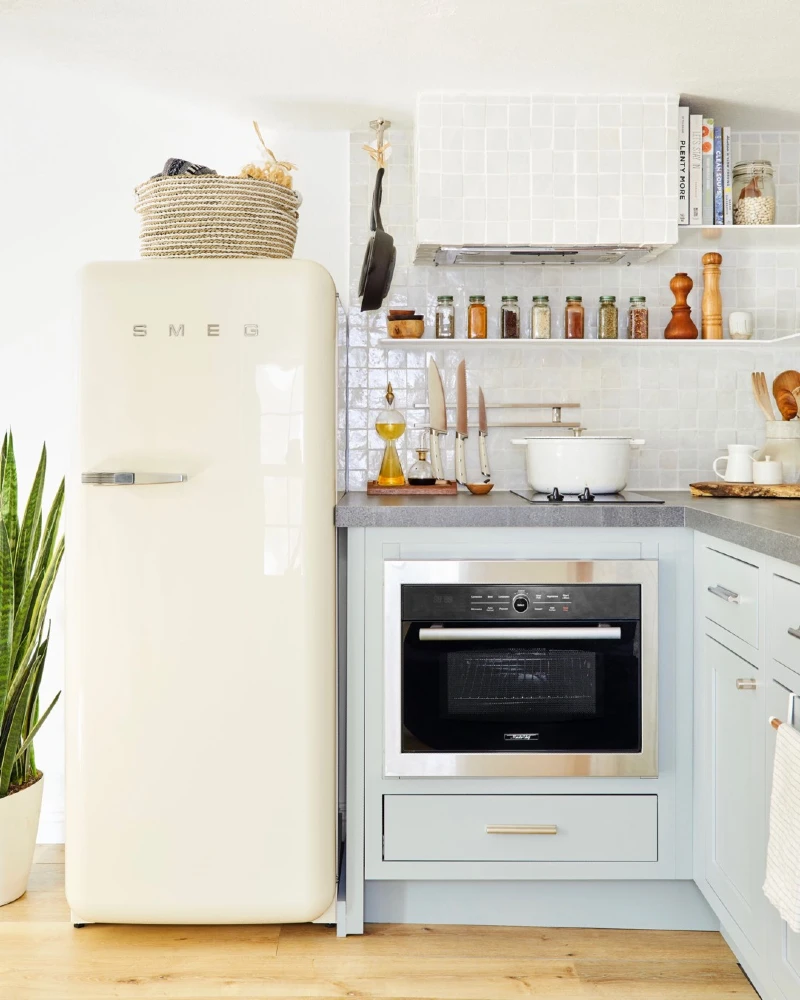 16. Retro Cream Fridge with Soft Blue Cabinets and Open Spice Shelving