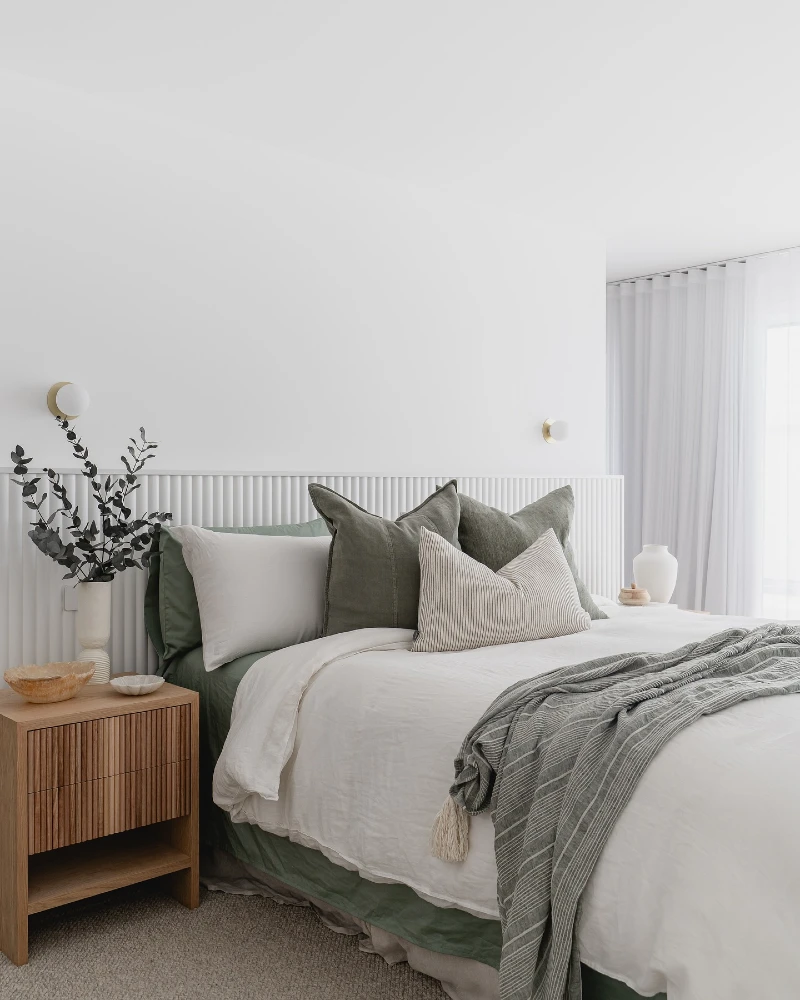 16. White Ribbed Headboard Wall with Sage Linen Layers and Fluted Wood Nightstand