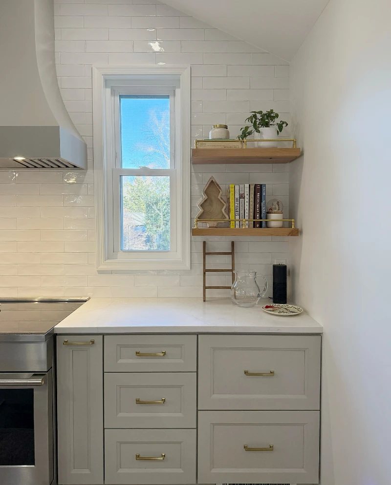 17. Kitchen Corner Shelves with Brass Rails, Cookbooks, and a White Plant Pot