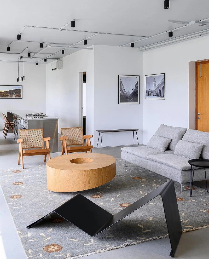 17. Round Wood Coffee Table with Cane Chairs, Gray Sofa, and Black Zigzag Lounge Seat