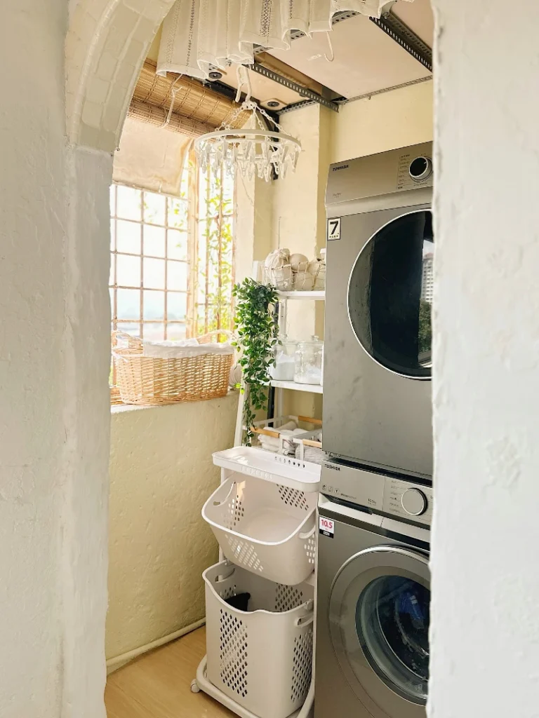 17. Sunlit Arched Laundry Nook with Stacked Machines, Ceiling Drying Rack, and Rolling Hampers