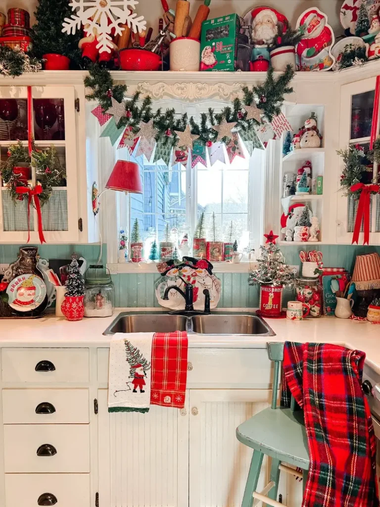 17. Vintage Sink Window with Star Garland, Red Plaid Throw, and Santa Shelf