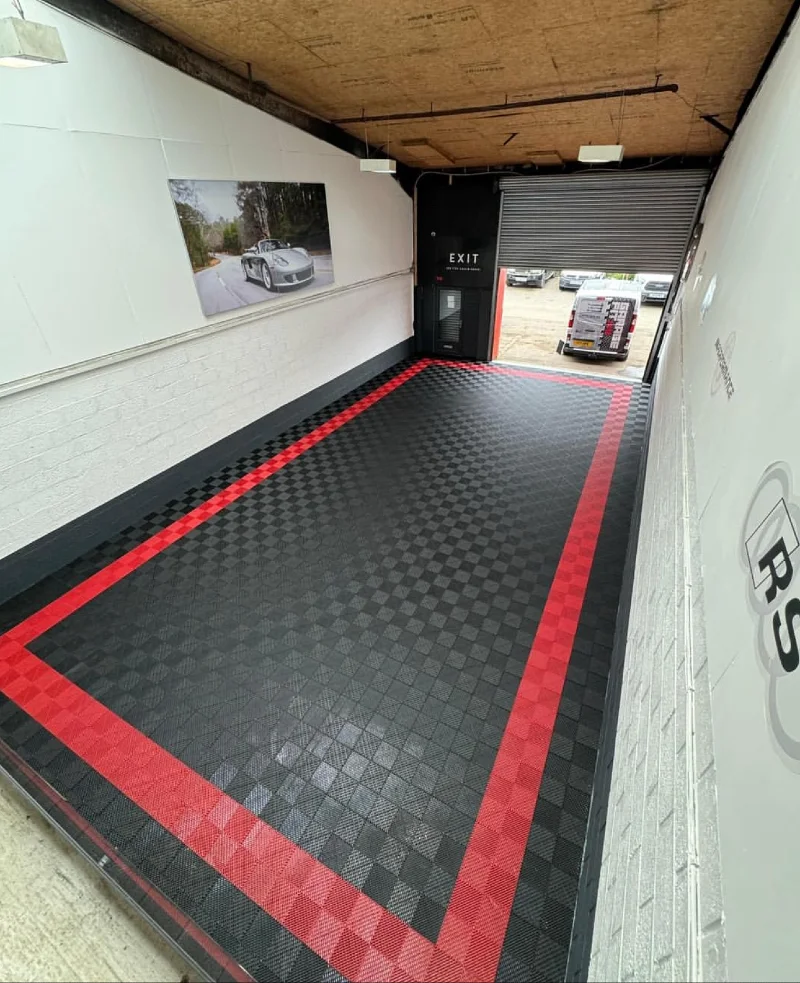 18. Black Interlocking Garage Floor with Red Border and White Brick Walls