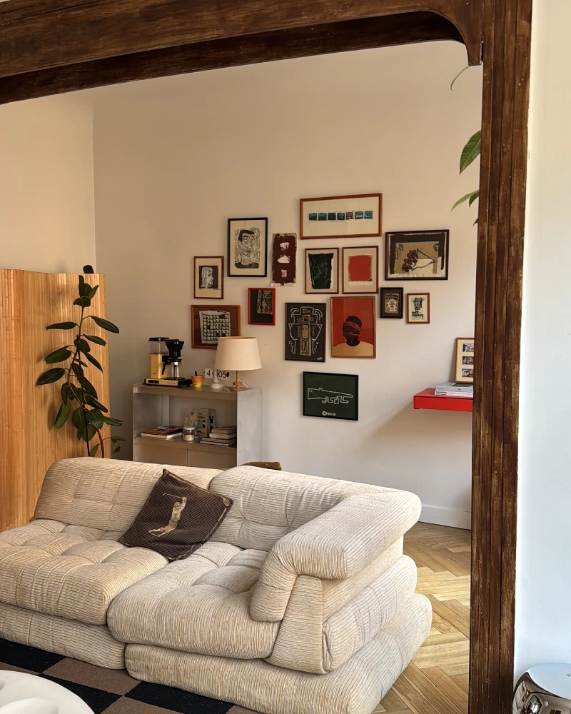 18. Eclectic Compact Gallery Wall with Floating Shelf and Warm Neutral Sofa Corner