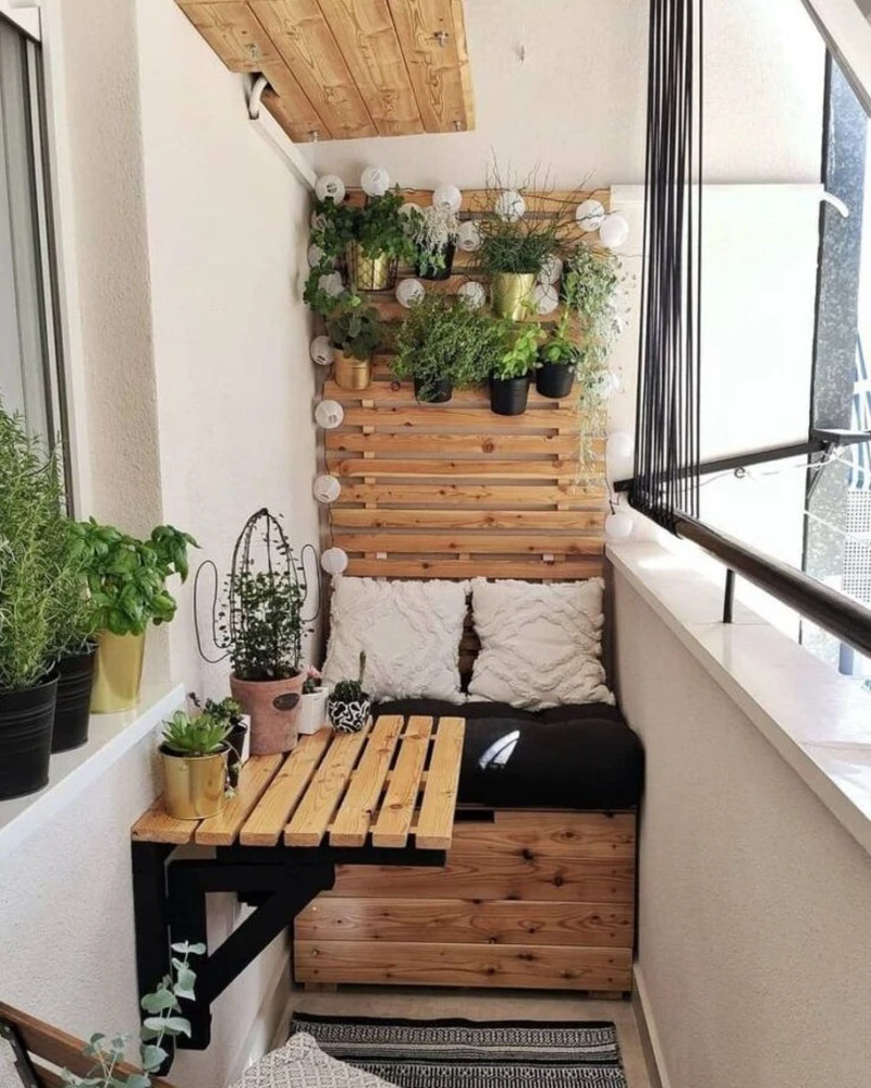 18. Pallet Bench Balcony with Plant Shelf Wall, Globe Lights, and Fold Out Wood Table