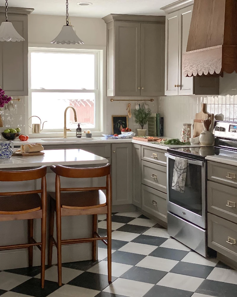 18. Taupe Cabinets with Checkerboard Floor and Scalloped Wood Range Hood Accent