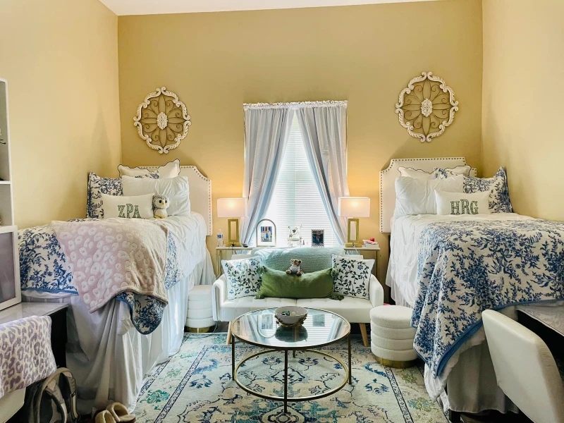 19. Blue Toile Shared Room with White Sofa, Gold Lamps, and Ornate Wall Accents