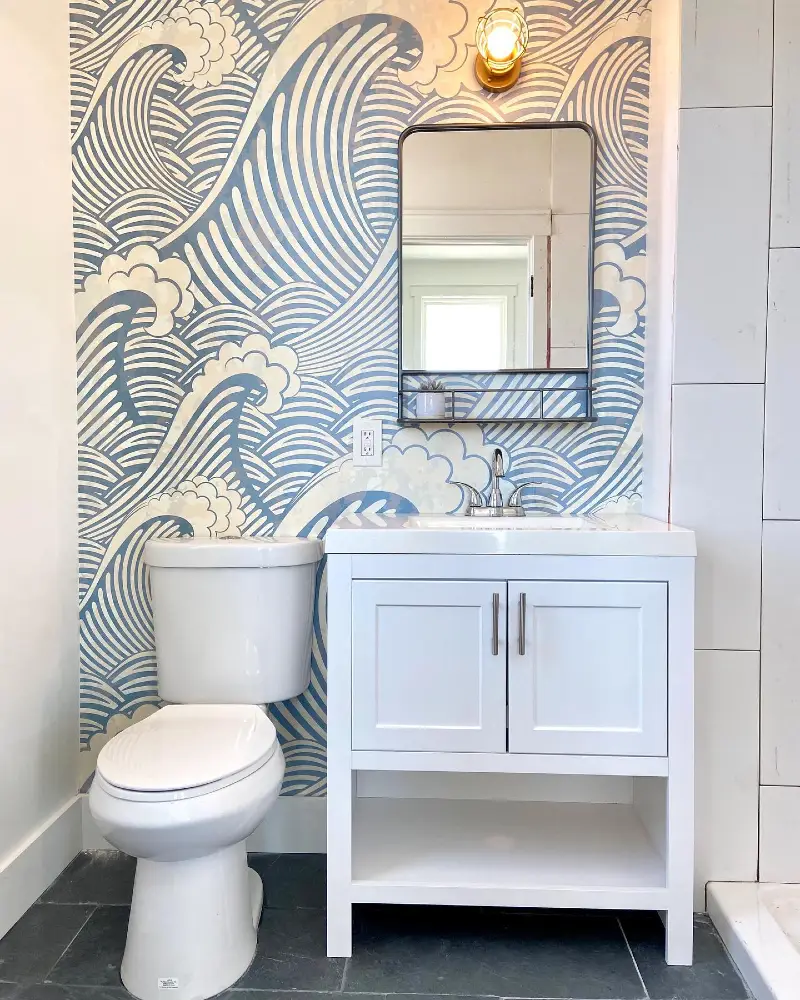 19. Blue Wave Mural Bathroom with White Vanity and Black-Framed Mirror