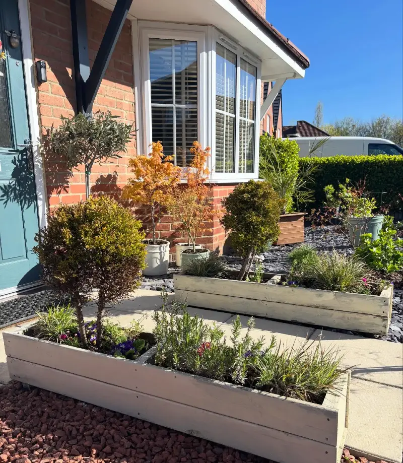 19. Cream Raised Planter Boxes with Blue Front Door, Slate Chippings, and Mini Trees
