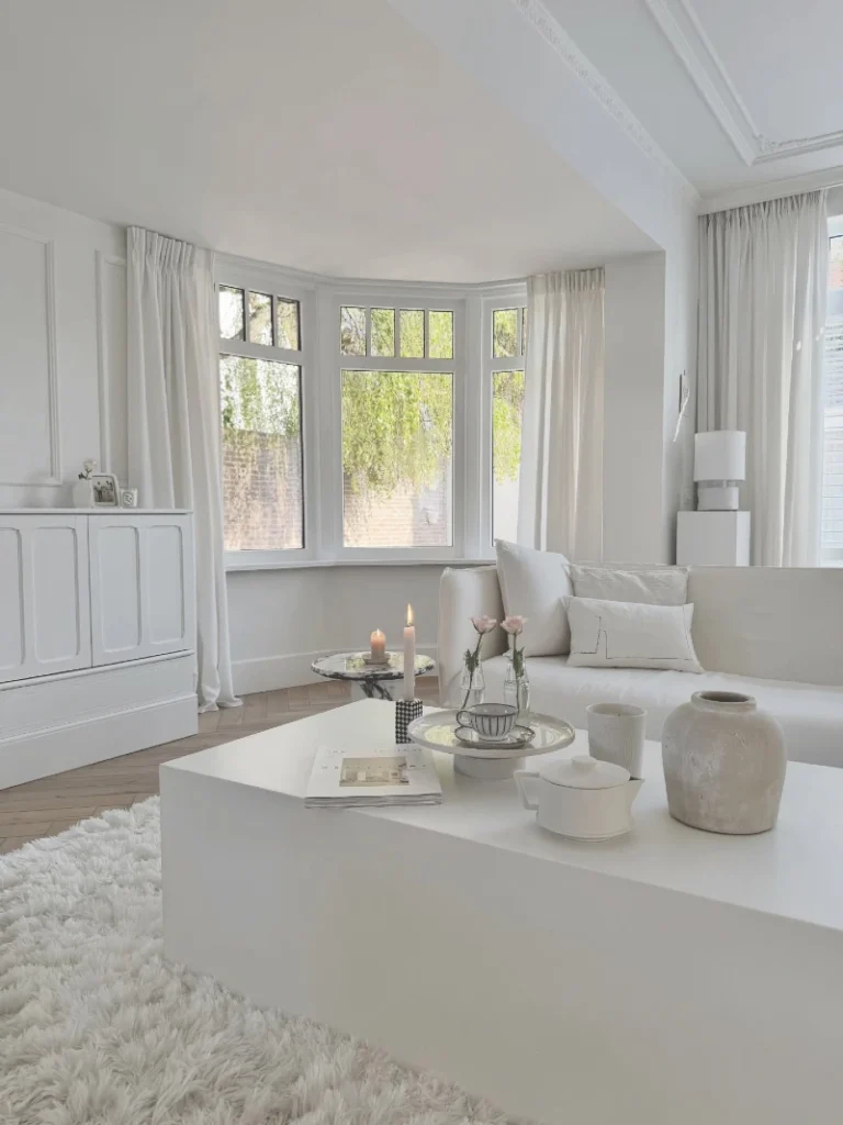 19. Matte White Coffee Table with Fluffy Rug and Bay Window Seating